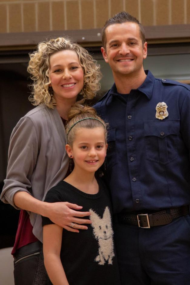 Rocklin firefighter Chris Marson stands with his wife and daughter.