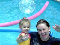 photo of mom & child in above-ground pool