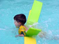 photo of boy in pool with floaties