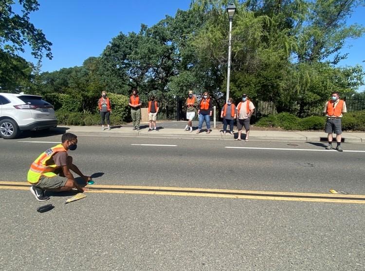 Mansour Brame installs a wildland access marker on a Rocklin street. 