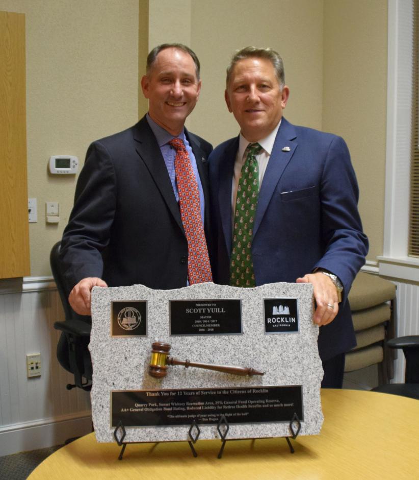 Councilmember Ken Broadway, left, and former Councilmember Scott Yuill celebrate Yuill's service. 