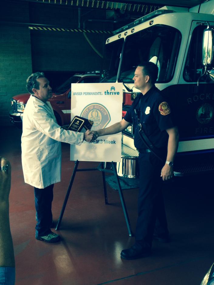 Fireman Wade receiving an EMS award from Dr Morris Kaiser Roseville 