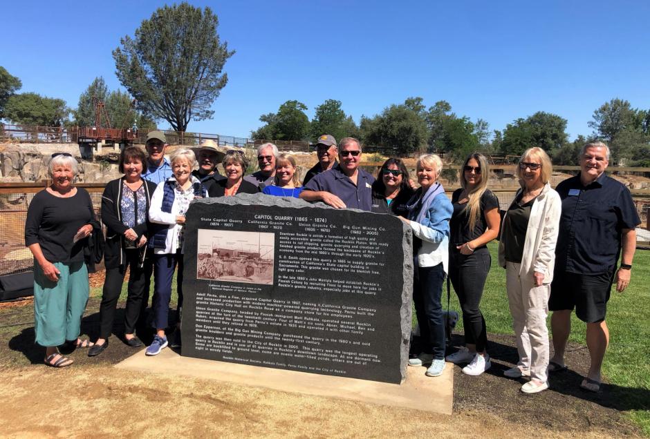 Members of the Rocklin Historical Society stand in front of monument they helped place at Quarry Park. 