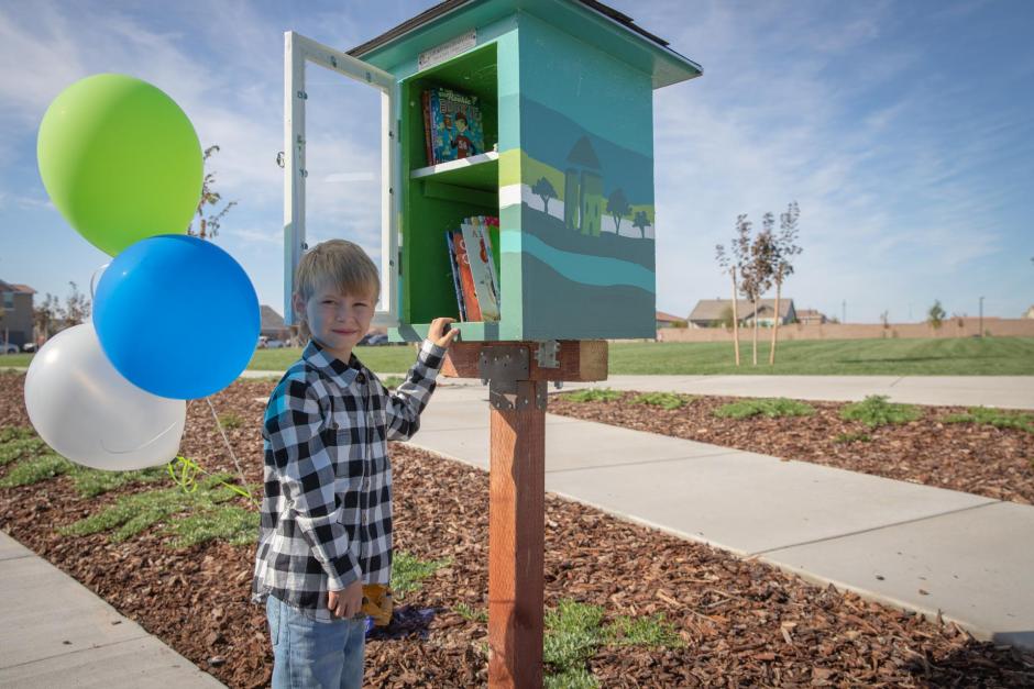 The Free Little Library, installed by a local Eagle Scout  candidate, allows children to pick a book to read.
