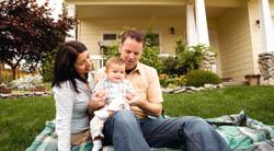 photo of family on front lawn of home