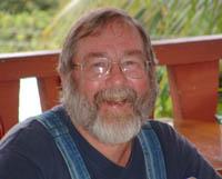 Photo of a senior man, outdoors, smiling.
