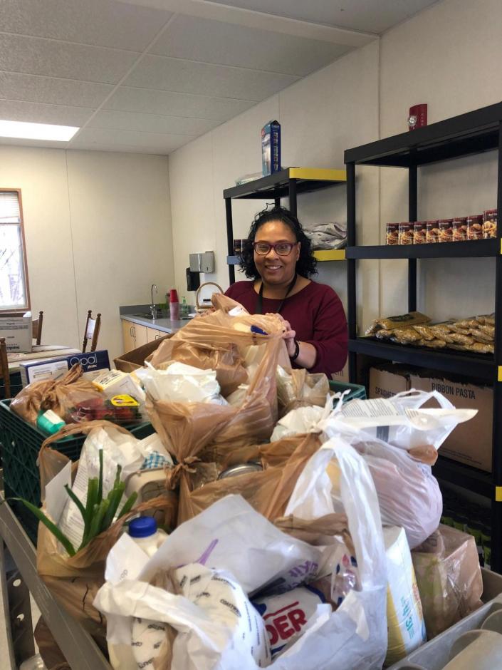 One of Stand Up Placer's Housing Team packs groceries for those in need.