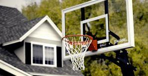 photo of basketball hoop with home in background