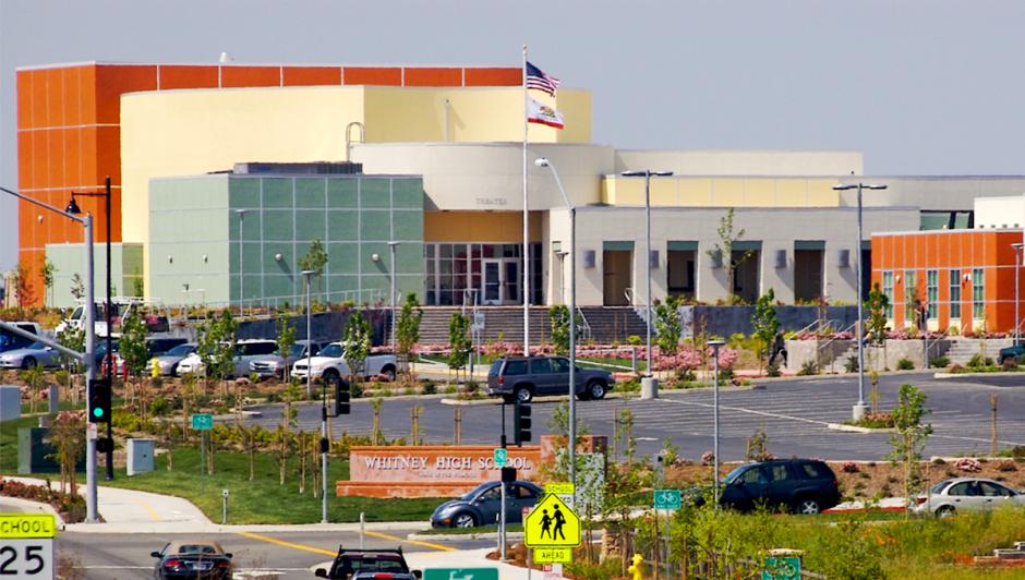 The orange and pale white exterior of Whitney High School in Rocklin, CA