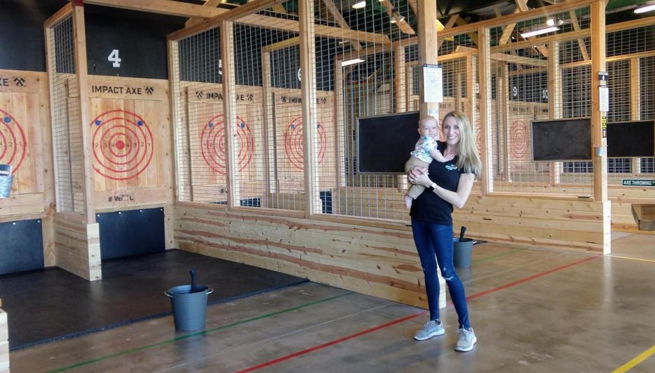 One of the owners, Kristi Torrington, stands with "Baby Bartender" James.