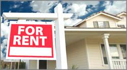 photo of "For Rent" sign in front of a home