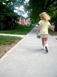 hild walking on sidewalk