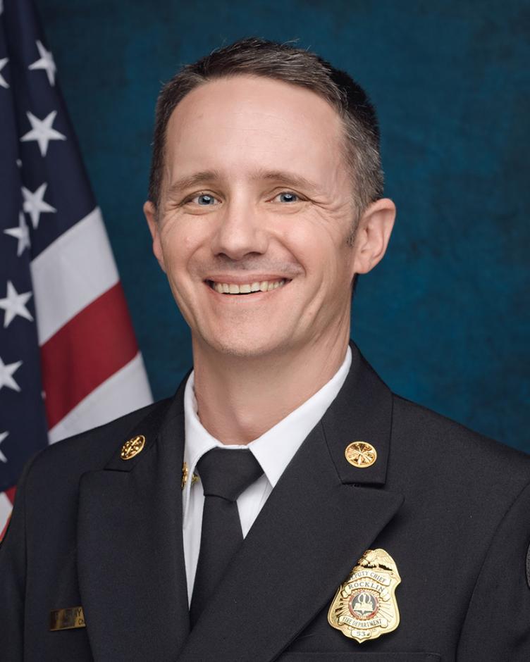 Formal portrait of Ryan Brayton, Deputy Fire Chief for Fire Prevention