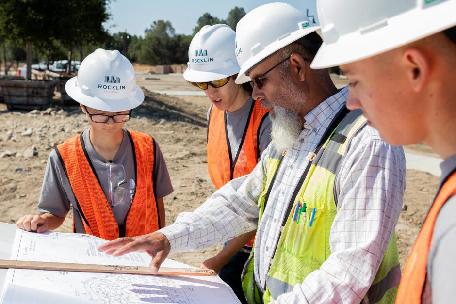 A City of Rocklin inspector goes over construction plans with students.